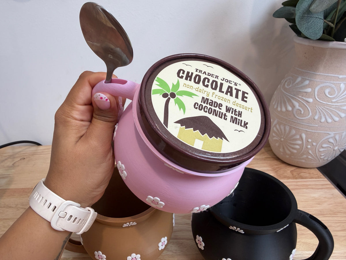 Overhead view of the pink Jarrito holder showing the pint and spoon slot